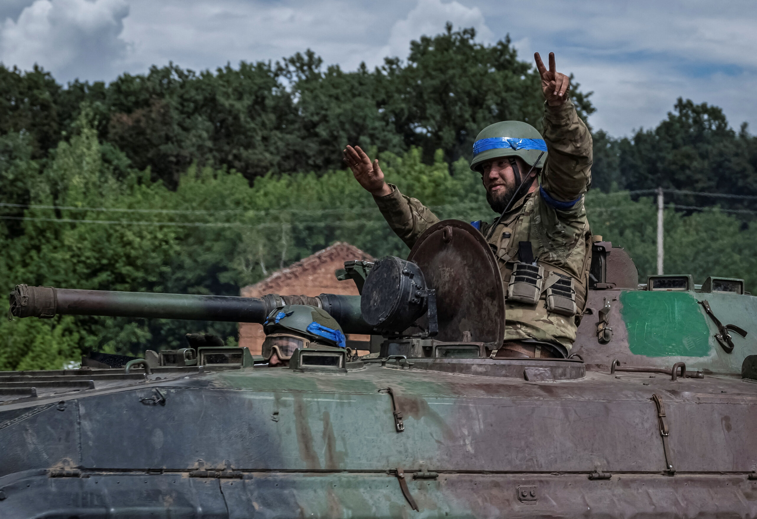 Ukrainian servicemen ride a BMP-1 infantry fighting vehicle near the Russian border in Sumy region